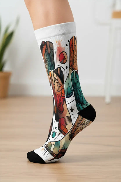 Colorful patterned socks on a wooden floor with a blurred background - Vibrant cowboy boot novelty socks for women by Zeblismapo
